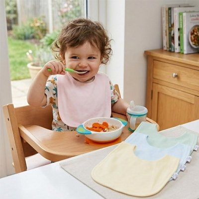 Bavoir bébé enfant qui mange tout souriant